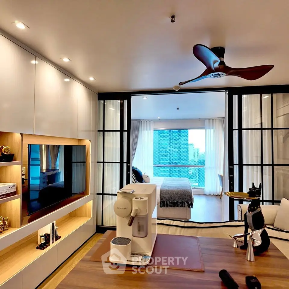 Modern living room with open layout and city view, featuring sleek furniture and stylish decor.