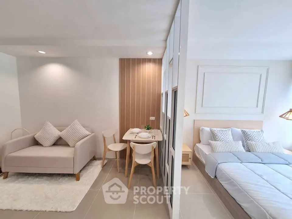 Modern studio apartment with cozy living area and stylish bedroom