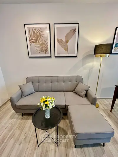 Stylish living room with modern gray sofa, chic decor, and elegant lighting, perfect for contemporary living.