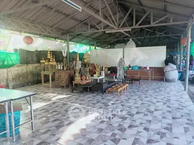 Spacious open-air pavilion with tiled flooring and traditional decor