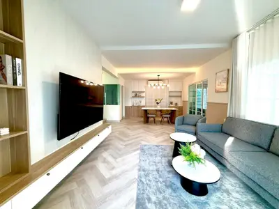 Spacious modern living room with stylish decor and open kitchen layout