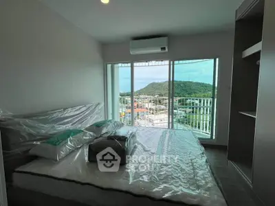 Modern bedroom with stunning mountain view and balcony access