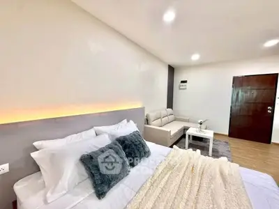 Modern bedroom with cozy bed and stylish decor in a spacious apartment.