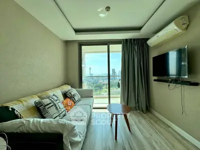 Modern living room with city view, cozy sofa, and wall-mounted TV, perfect for relaxation.