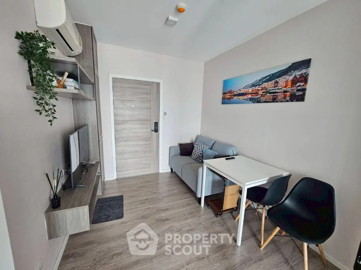 Modern living room with sleek furniture and wall-mounted TV