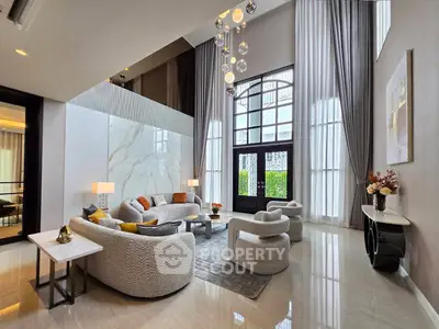 Luxurious high-ceiling living room with modern furniture and elegant decor