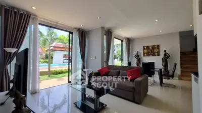 Spacious living room with modern decor and pool view in luxury home