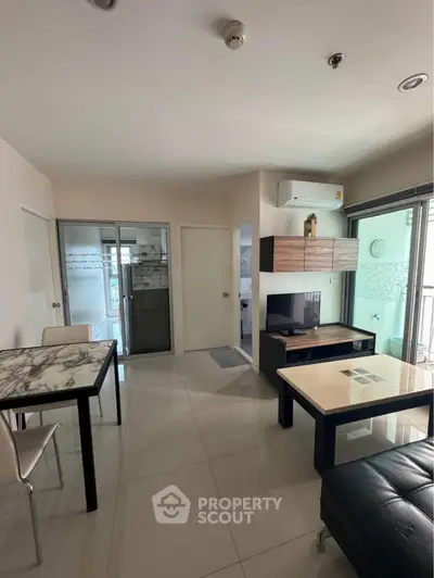 Modern living room with sleek furniture and natural light in a stylish apartment.