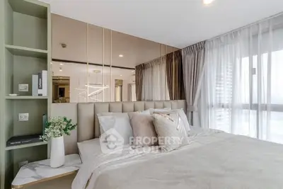 Luxurious bedroom with elegant decor and large windows offering ample natural light.