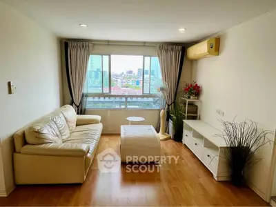 Bright living room with city view, cozy sofa, and modern decor