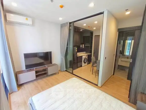 Modern studio apartment with open layout, featuring a cozy living area, compact kitchen, and stylish bathroom.