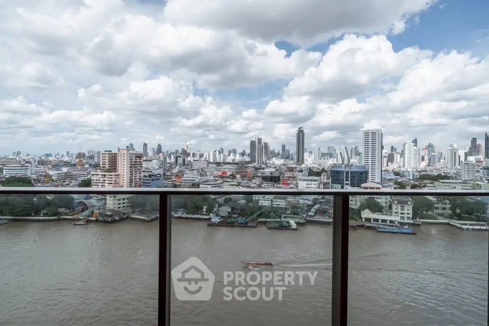 Stunning cityscape view from a high-rise balcony overlooking a river, perfect for urban living enthusiasts.