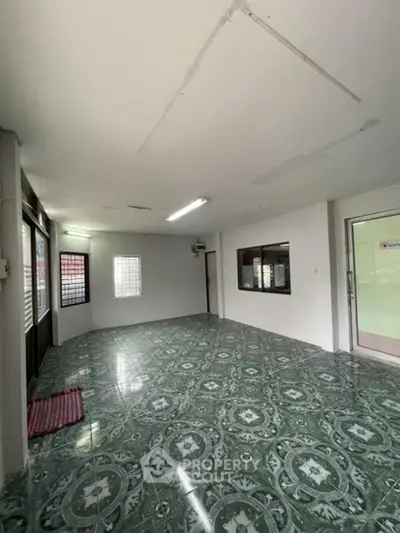 Spacious interior with patterned tile flooring and ample natural light
