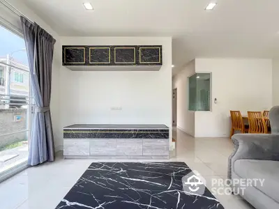 Modern living room with marble accents and elegant dining area