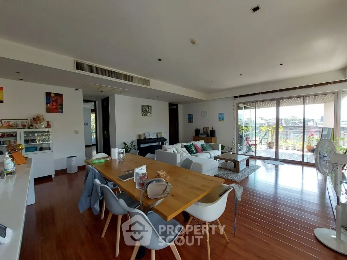Spacious living room with modern decor and large balcony view