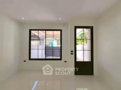 Bright and modern empty room with large window and door, perfect for customization.