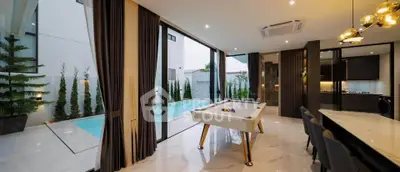 Luxurious modern living room with pool view and billiards table