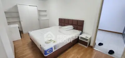 Spacious bedroom with modern furnishings and wooden flooring, perfect for comfortable living.