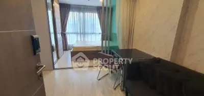 Modern studio apartment with glass partition and cozy furnishings