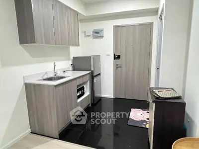 Modern kitchen with sleek cabinetry and stainless steel appliances in a compact layout.