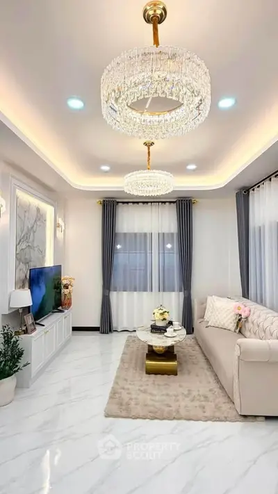 Luxurious living room with elegant chandeliers and plush furnishings