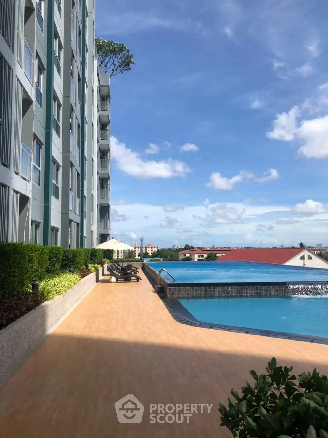 Luxurious apartment building with stunning rooftop pool and panoramic city views.