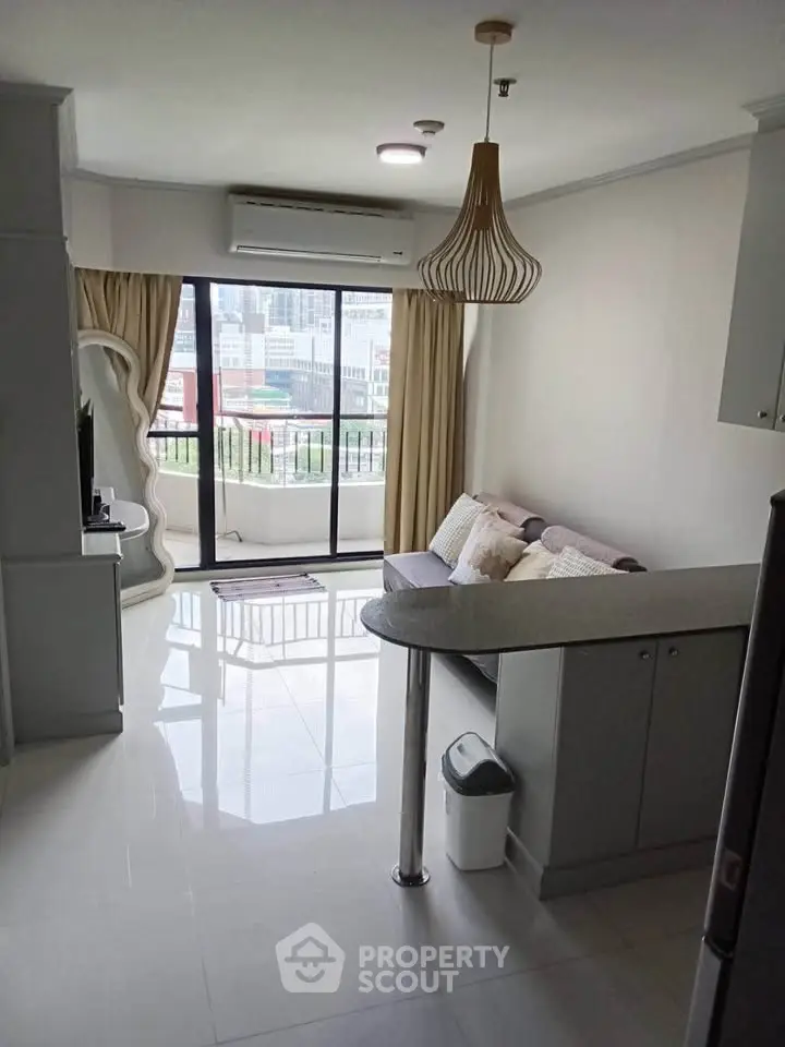 Modern living room with balcony view in urban apartment, featuring stylish decor and natural light.