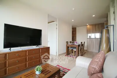 Spacious living room with modern decor and open dining area in a stylish apartment.