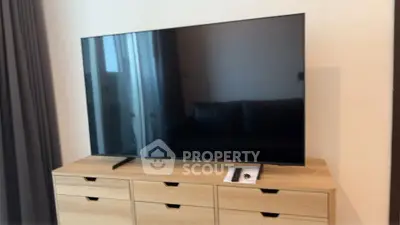 Modern living room with sleek TV on stylish wooden cabinet