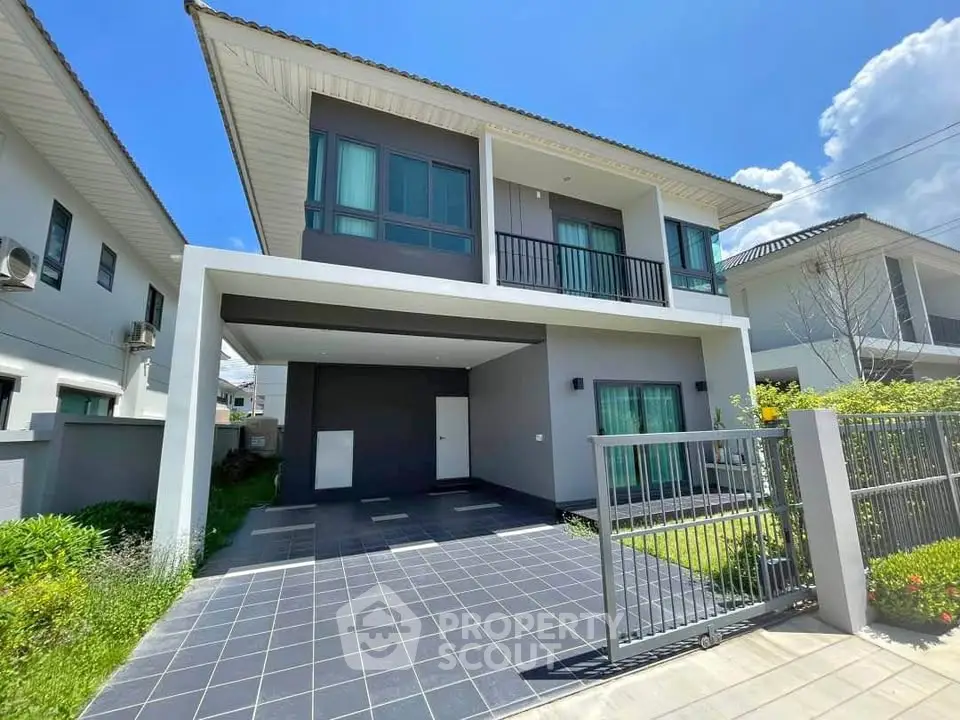 Modern two-story house with spacious driveway and lush garden