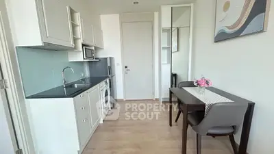 Modern compact kitchen with dining area in stylish apartment