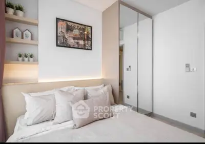 Modern bedroom with stylish decor and mirrored wardrobe