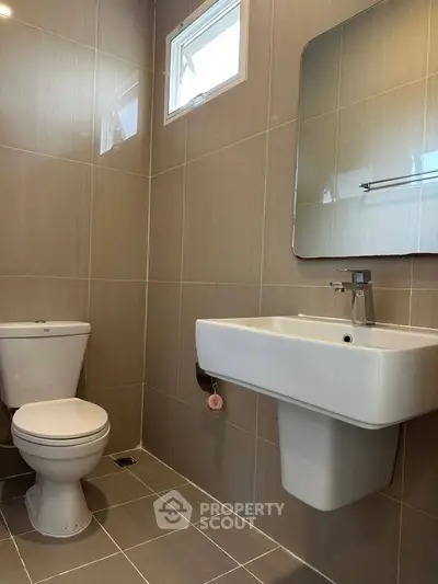 Modern bathroom with sleek fixtures and neutral tile design