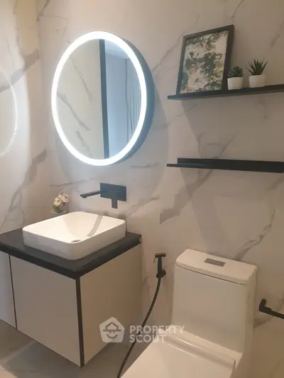 Modern bathroom with illuminated mirror and sleek fixtures