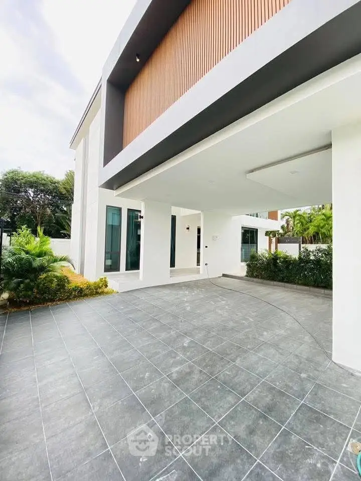 Modern architectural exterior with sleek design and spacious driveway