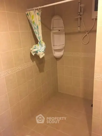 Spacious bathroom with tiled walls and shower area, ideal for modern living.