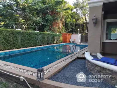 Charming backyard with private swimming pool and lush greenery, perfect for relaxation and entertainment.