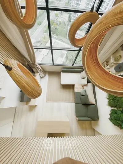 Stunning modern living room with floor-to-ceiling windows and unique wooden light fixtures.