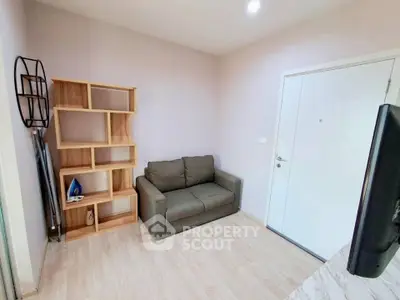 Cozy living room with modern sofa and stylish wooden shelving unit.