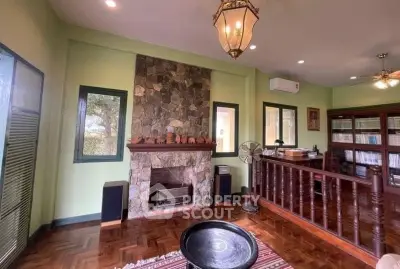 Charming living room with stone fireplace and wooden flooring