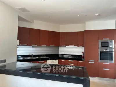 Modern kitchen with sleek cabinetry and built-in appliances in a contemporary apartment.