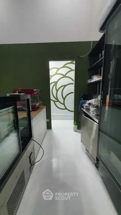 Modern kitchen with sleek appliances and unique wall design