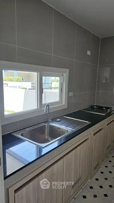 Modern kitchen with sleek countertops and gas stove in contemporary home