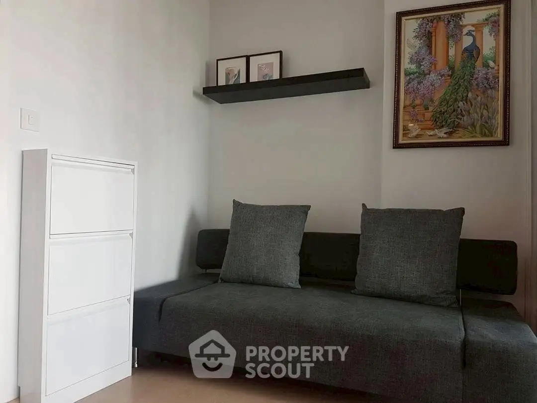 Cozy living room with modern gray sofa and elegant wall art, perfect for relaxation.