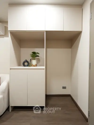 Modern storage unit in a stylish living space with sleek cabinetry and decorative accents.