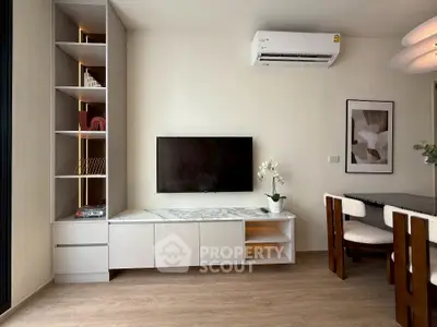 Modern living room with wall-mounted TV and stylish furniture