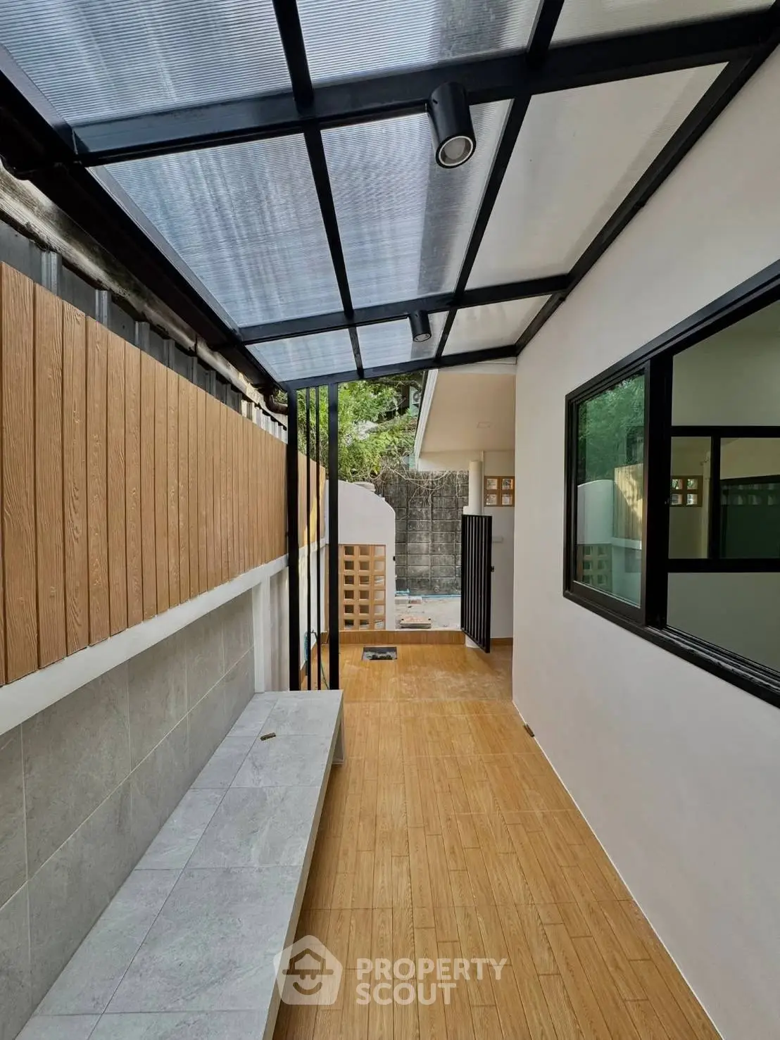 Modern outdoor corridor with wooden flooring and glass roof