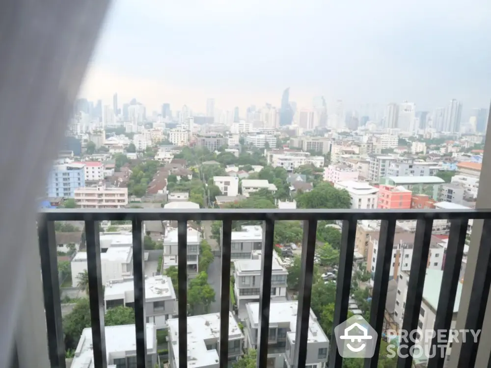 Stunning cityscape view from high-rise balcony overlooking urban skyline.