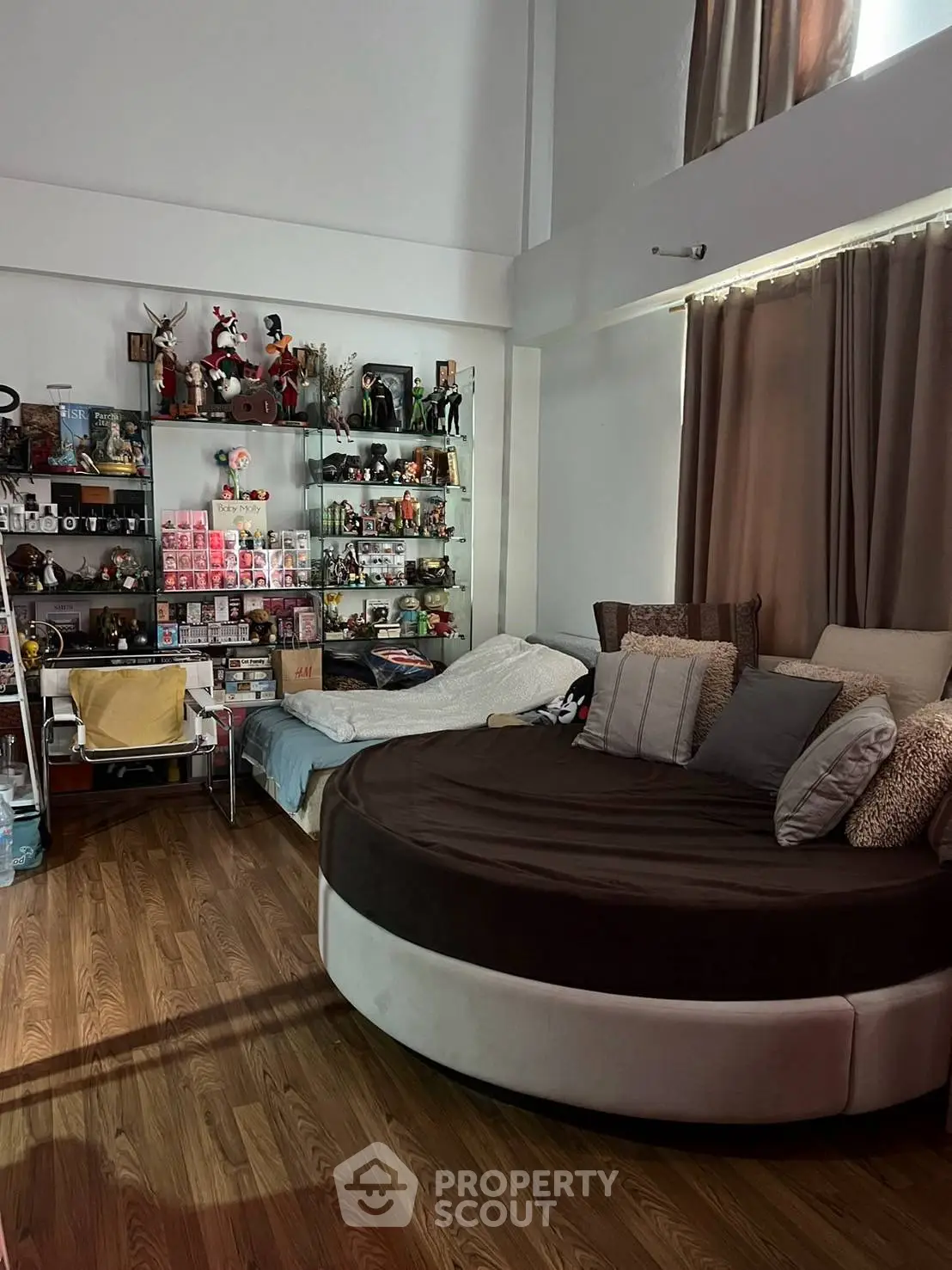 Cozy living room with unique round sofa and display shelves