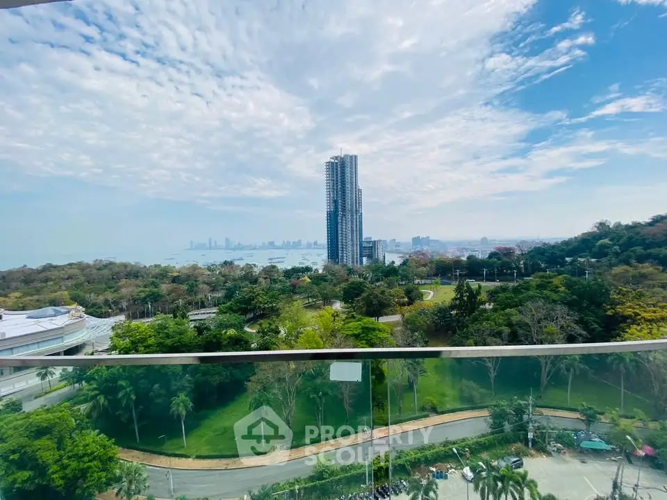 Stunning high-rise view of lush greenery and city skyline from a balcony, perfect for urban living.